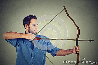 Man drawing a bow Stock Photo