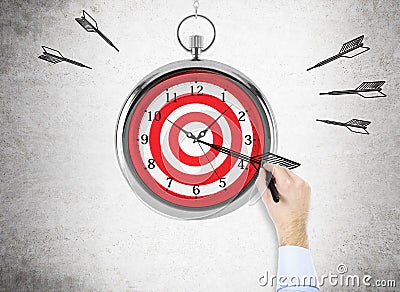 Man drawing dart on clock Stock Photo