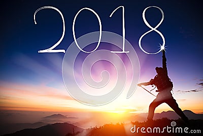 Man drawing 2018 by flashlight on top of mountain Stock Photo