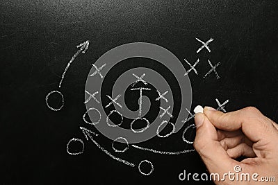 Man drawing football game scheme on chalkboard Stock Photo