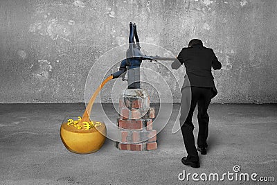 Man drawing golden sand currency symbols retro pump concrete room Stock Photo