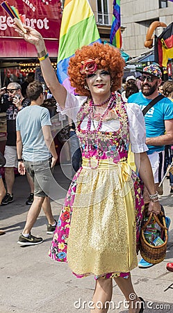 2018: A man dressed in extravagant female clothes attending the Gay Pride parade also known as Christopher Street Day CSD in MUC Editorial Stock Photo