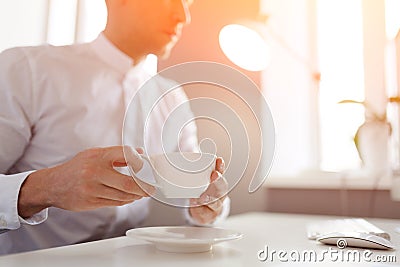 Man drinking coffee at desktop Stock Photo