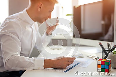 Man drinking coffee at the workplace Editorial Stock Photo