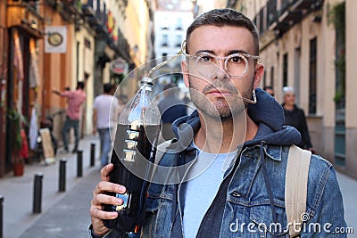 Man drinking an unhealthy amount of soda outdoors Stock Photo