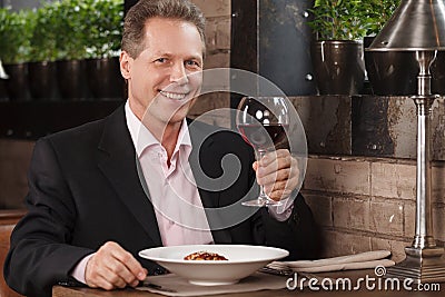 Man drinking wine. Portrait of cheerful businessman drinking Stock Photo