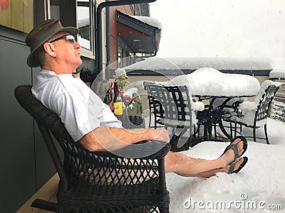 Man Drinks Beer in Snow Storm During a Northwest Summer Stock Photo