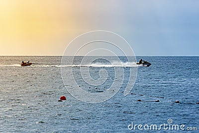 Man drive freestyle jet ski at summer sunset. Summer background Editorial Stock Photo