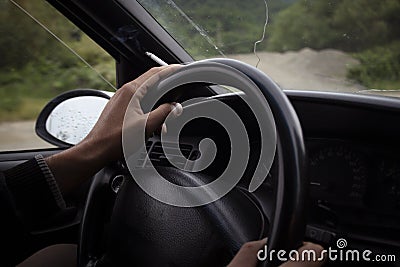 A man drives a car and smokes Stock Photo