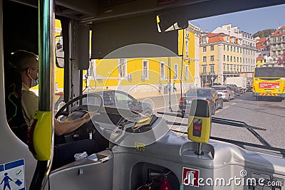 Man driving an autobus during the day in Lisbon Editorial Stock Photo