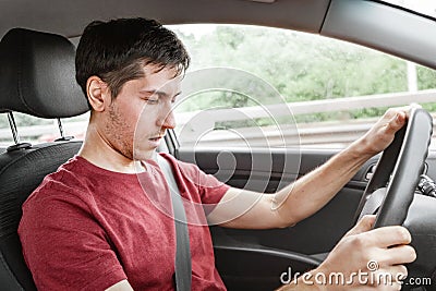 Man driving car fell asleep and does not control the road situation. Drugged with alcohol or insomnia concept. Car crashes and Stock Photo