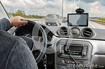 Man driving car with hands on the steering wheel and using the GPS navigation Stock Photo