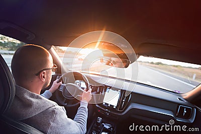 Man driving a car. Success in motion. Handsome young man driving a car. A man holds the steering wheel of a car Stock Photo