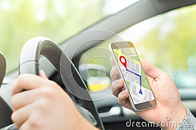Man driving car and using online map and GPS application. Stock Photo