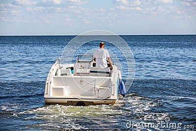 Man driving a fast boat Stock Photo
