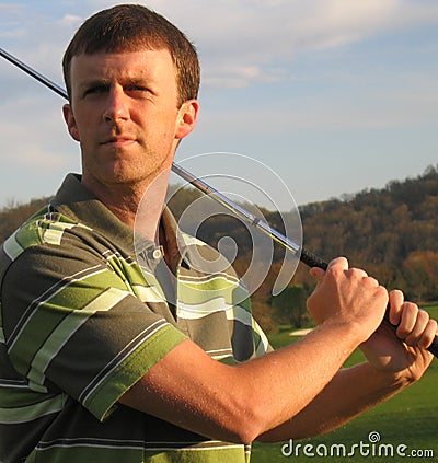 Man Driving Golf Ball at Tee Time Stock Photo