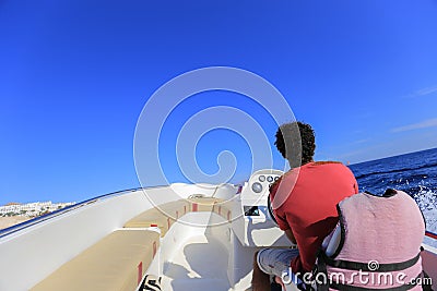 Man driving motor boat, view forward from a motor boat Editorial Stock Photo