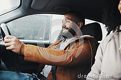 Man driving, rain and smile in city with car journey, winter travel and happiness for road trip. Guy driver Stock Photo