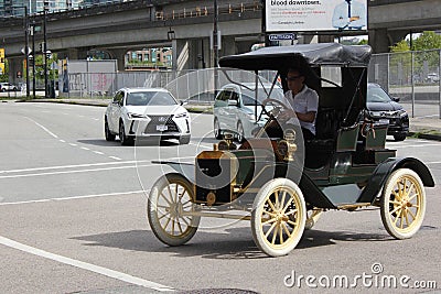 Man driving Retro Ford Model R car in downtown Vancouver, British Columbia, Canada Editorial Stock Photo