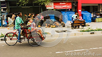 A man driving a trishaw with passenger Editorial Stock Photo