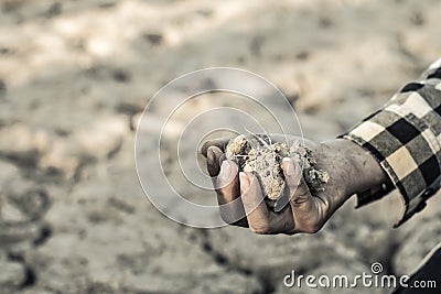 Man on a drought-stricken land in hopes of recovering. Stock Photo