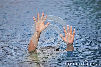 Man drowning in out door swimming pool while swimming alone, raising two hands and asking for help SOS Stock Photo