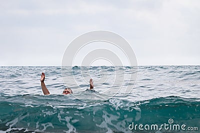 Man drowns and raising his hands up Stock Photo