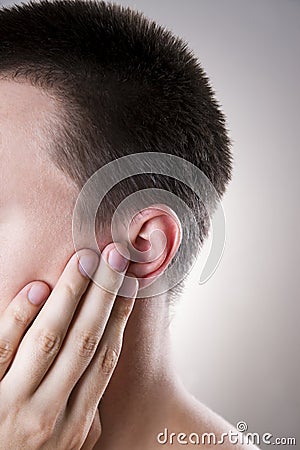 Man with a earache. Pain in the human body Stock Photo