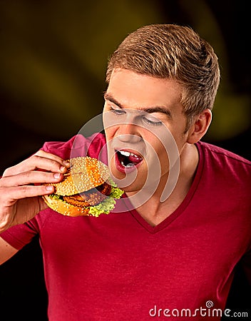 Man eat hamburger. Fastfood and junk food concept. Stock Photo