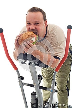 Man eating huge hamburger on a trainer device Stock Photo