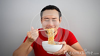 Man eating instant noodles. Stock Photo