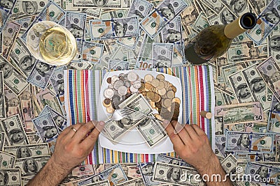 Man eating money through extravagance Stock Photo