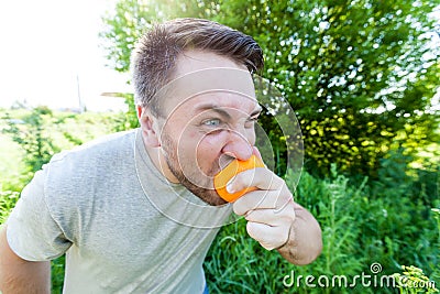 Man eating oranger Stock Photo