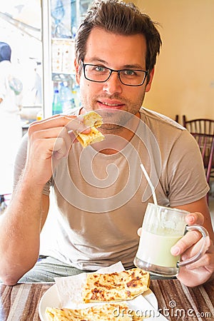 Man eating traditional moroccan breakfast in coffee shop. Stock Photo