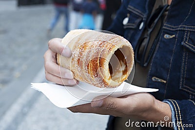 Man eating a typical Czech trdelnik in Prague Stock Photo