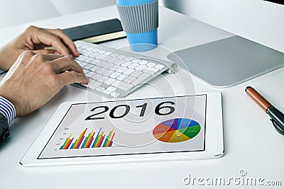 Man with the economic forecast for 2016 in his tablet Stock Photo