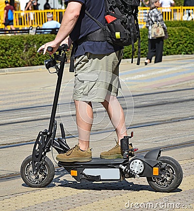 Man on an electric scooter on the city street Stock Photo