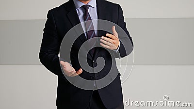 Man in an elegant suit gesturing during a performance, speech or presentation. Leader, lawyer, businessman or politician. Stock Photo