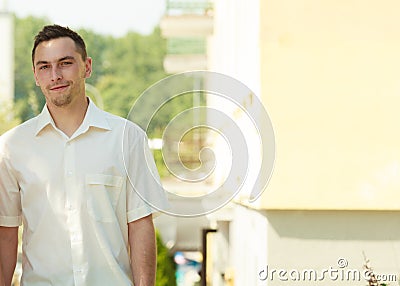 Man in elegant white summer shirt outside. Stock Photo