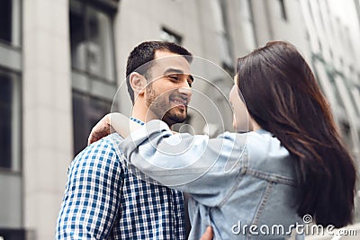 Man embraces girl on background of building. Stock Photo