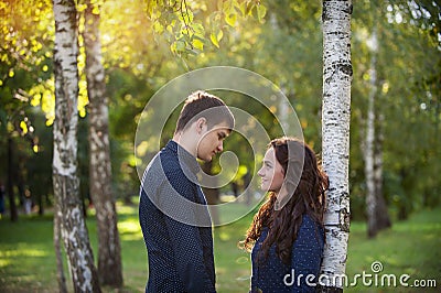 Man embraces girl on a walk in the autumn park Stock Photo