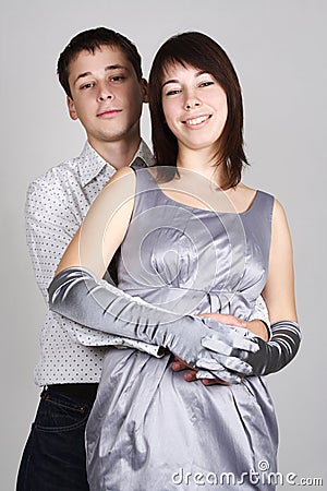Man embracing woman in evening dress from back Stock Photo