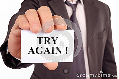 Man holding a card on which is written try again Stock Photo