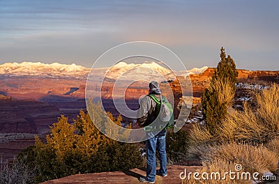 Man enjoying beautiful sunset in winter in the mountains in Utah. Stock Photo