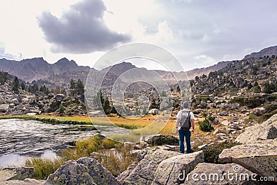 Man enjoying a natural mountain landscape in the Pyrenees, Andorra, Estany Pessons Stock Photo