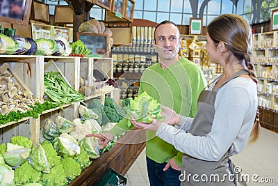Man enquiring about Romanesco broccoli Stock Photo