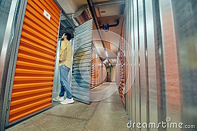 Man entering open garage door in warehouse Stock Photo