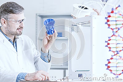 Man examinig the 3D printout Stock Photo