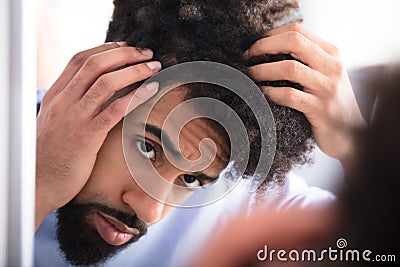 Man Examining His Hair Stock Photo