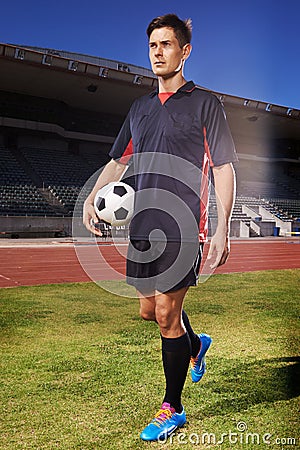 Man, exercise and confident soccer player in stadium, athlete and competitive for match or game. Male person, serious Stock Photo